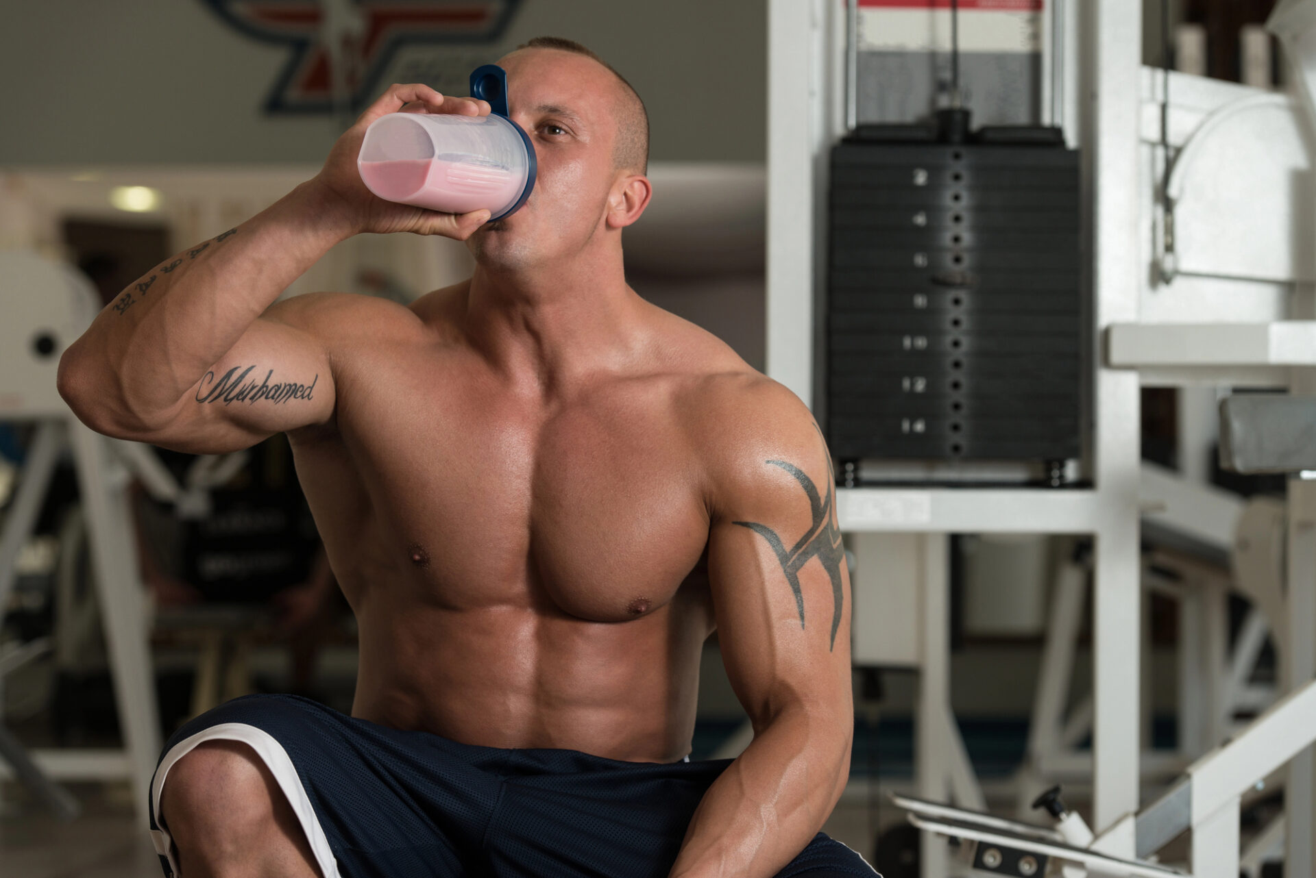 Picture of a bodybuilder drinking a protein shake.